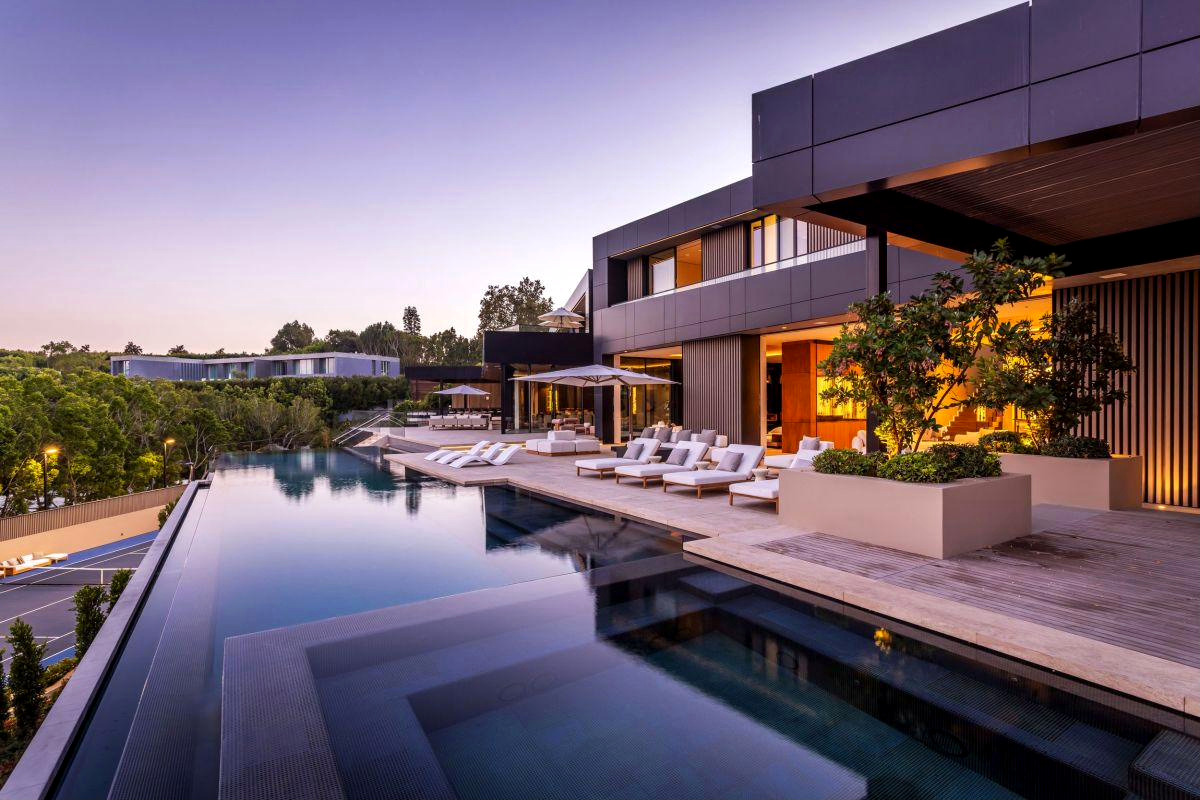 Completed Roman James residence at dusk, pool and terrace in the foreground