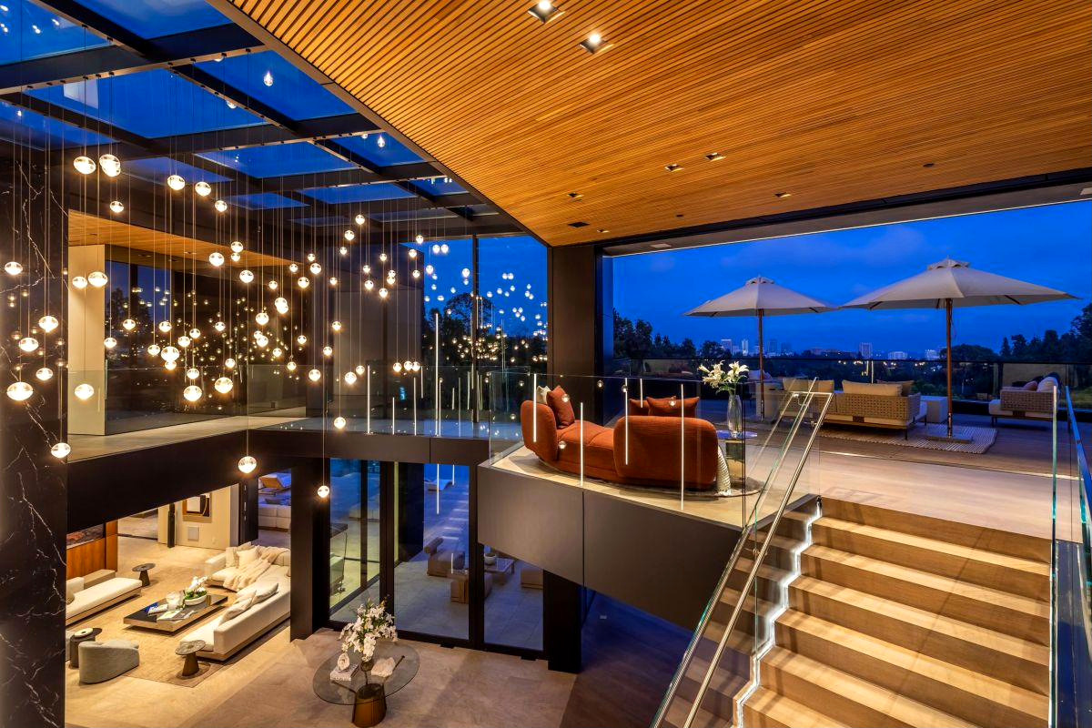 Completed Roman James residence, hillside elevation with pool deck at dusk