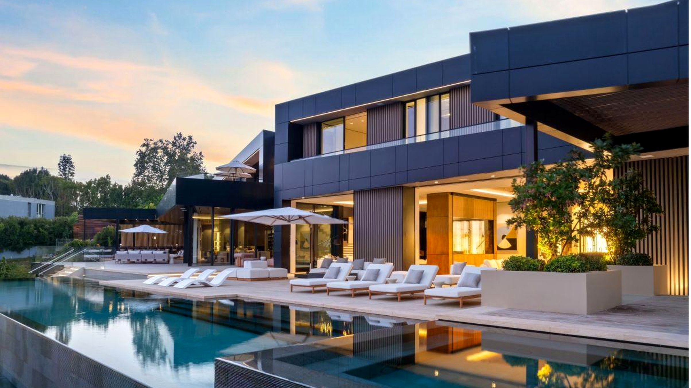Completed Roman James residence at dusk, pool and terrace in the foreground