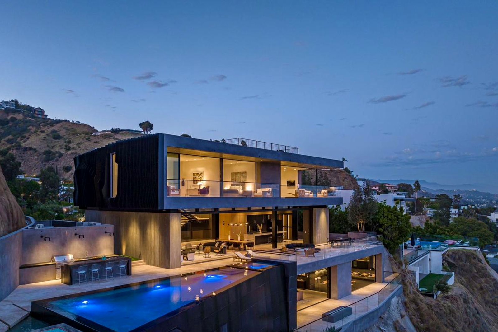 Cantilevered residence above the city at blue hour
