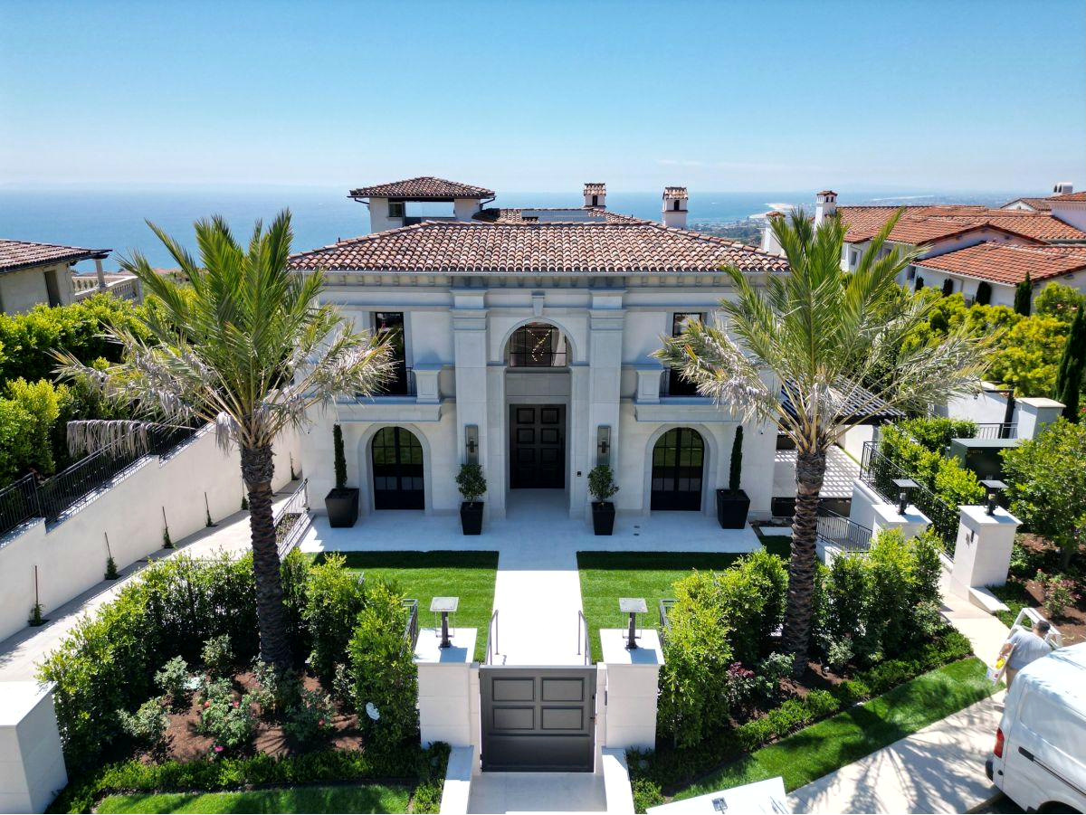 Mediterranean style estate with tile roof and motor court