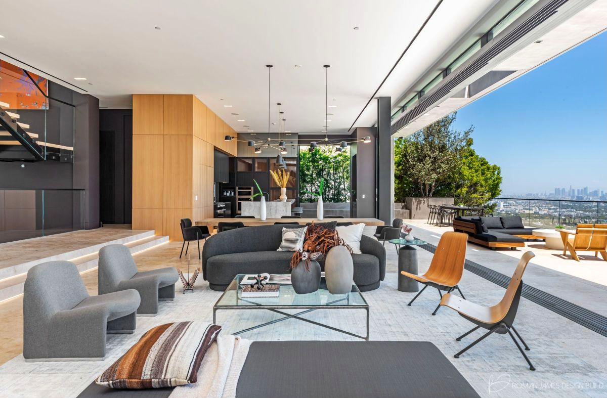 Living room opening to a hillside view