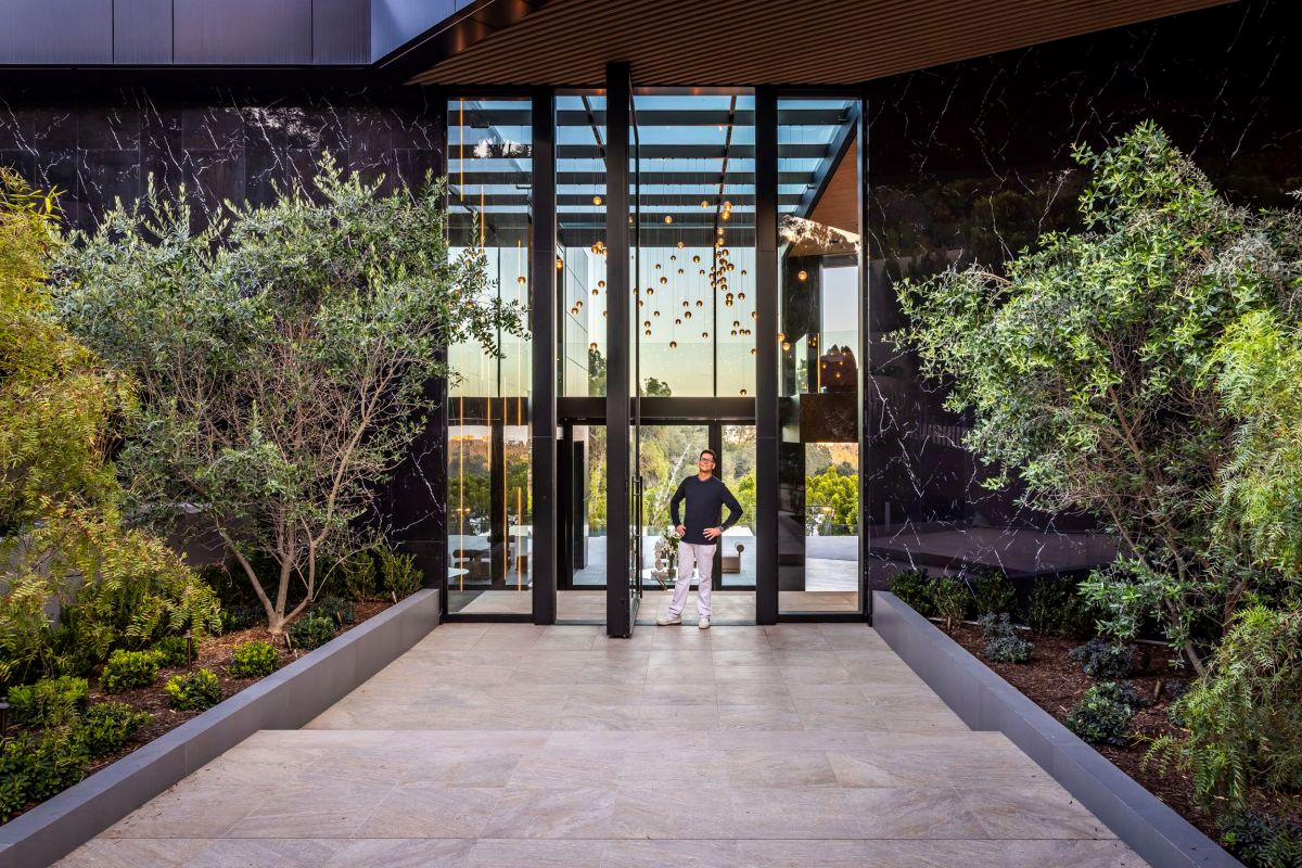Glass entry seen through mature trees