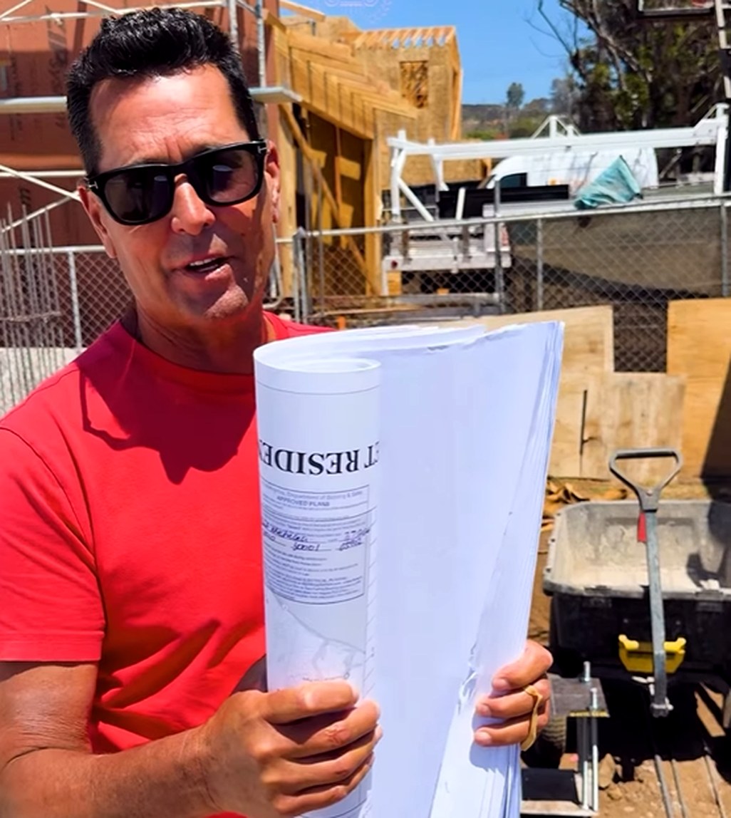 Roman James on the Pacific Palisades site holding the City of Los Angeles approved plan set